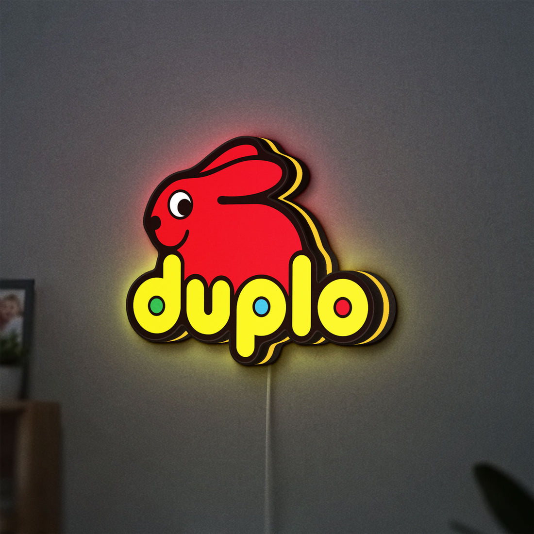 Duplo Lego LED lightbox hanging on a wall with yellow glow