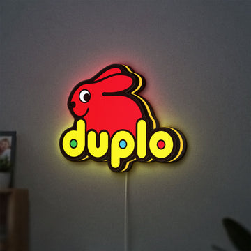Duplo Lego LED lightbox hanging on a wall with yellow glow