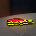 Duplo Lego LED lightbox lying flat on a desk with yellow glow