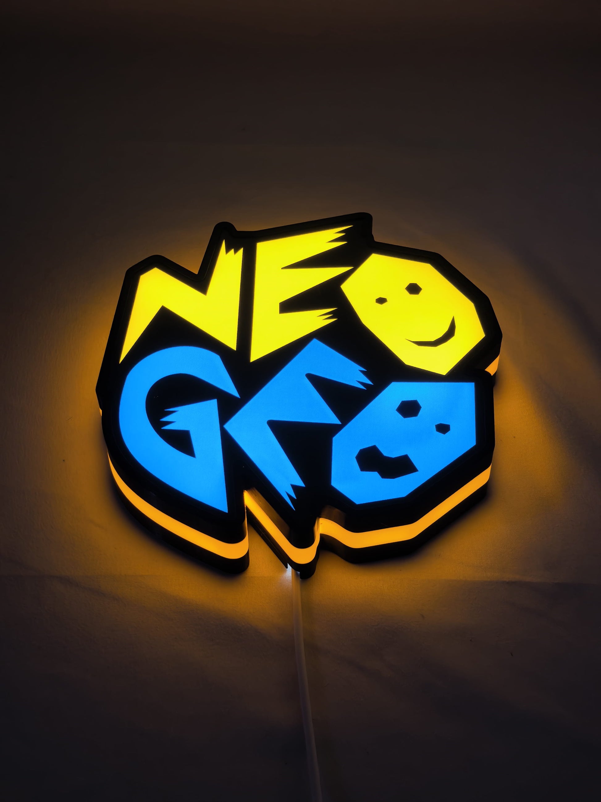 20cm Neo Geo Arcade Glowing Wall Art - Illuminated flat lay angled view, unique wall art for desk and room decor
