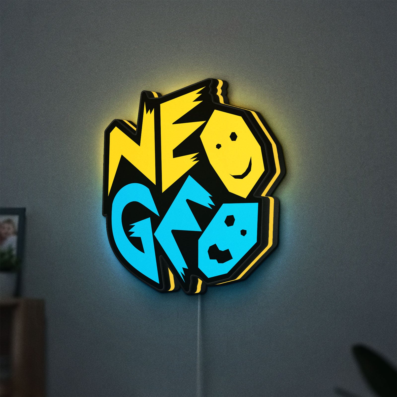 Neo Geo Arcade LED lightbox hanging on a wall with yellow glow