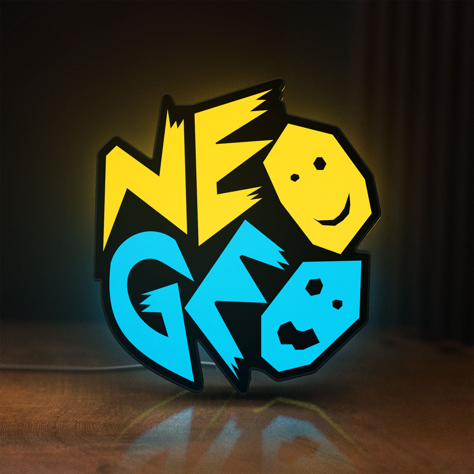 Front view of Neo Geo Arcade LED lightbox sign glowing on a wooden desk