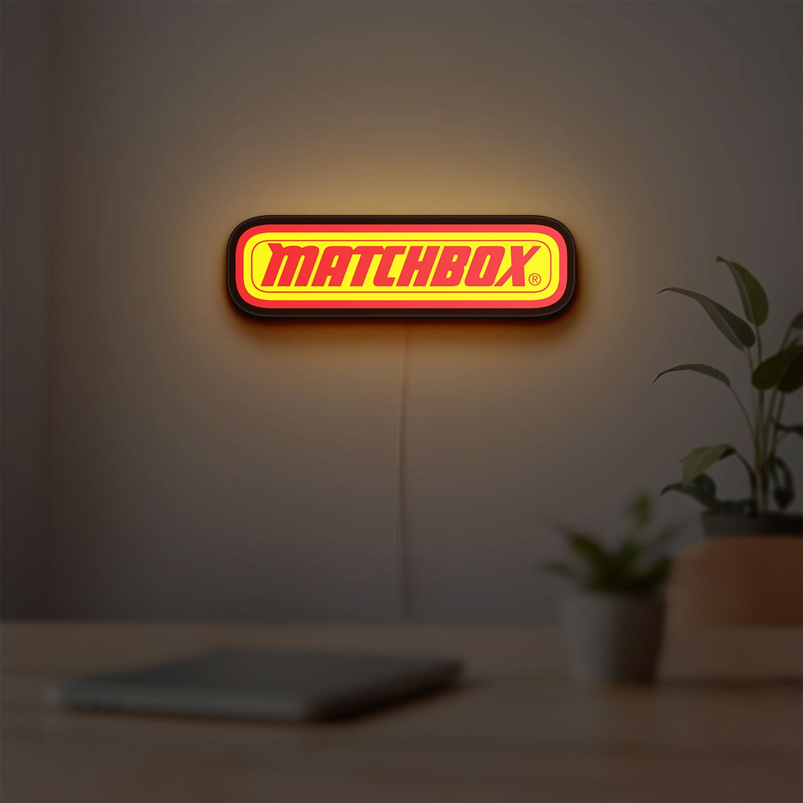 Matchbox LED lightbox hanging on a room wall with soft yellow light