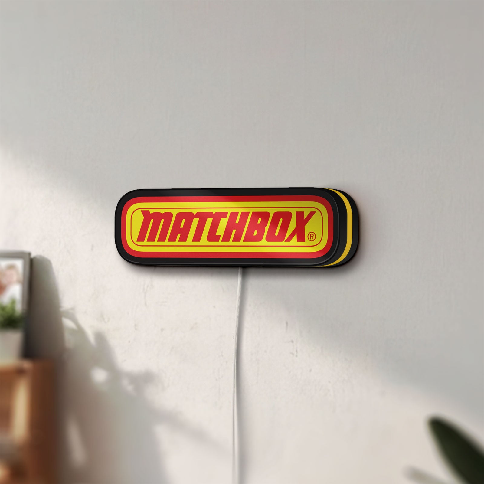 Unlit Matchbox LED lightbox mounted on a wall in daylight