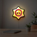 Brawl Stars LED lightbox hanging on a room wall with soft yellow light