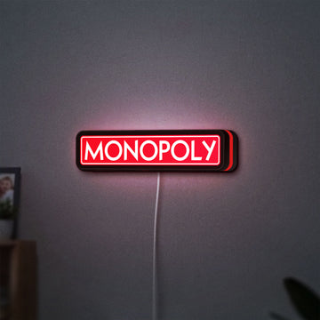 Monopoly Money Bag LED lightbox hanging on a wall with red glow
