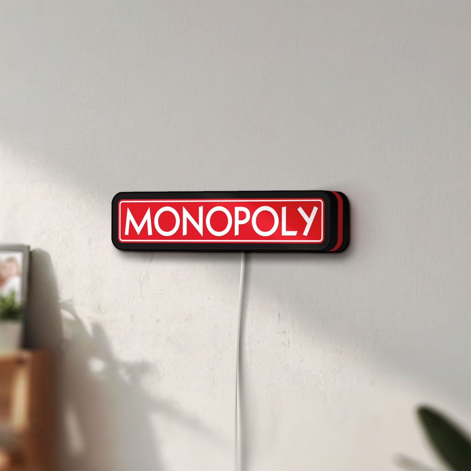 Unlit Monopoly Money Bag LED lightbox mounted on a wall in daylight