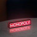 Monopoly Money Bag LED lightbox standing on a desk from an angled side view with red glow