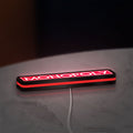 Monopoly Money Bag LED lightbox lying flat on a desk with red glow