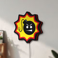 Unlit Serious Sam Bomb LED lightbox mounted on a wall in daylight