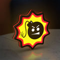 Serious Sam Bomb LED lightbox standing on a desk from an angled side view with red glow