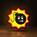 Front view of Serious Sam Bomb LED lightbox sign glowing on a wooden desk