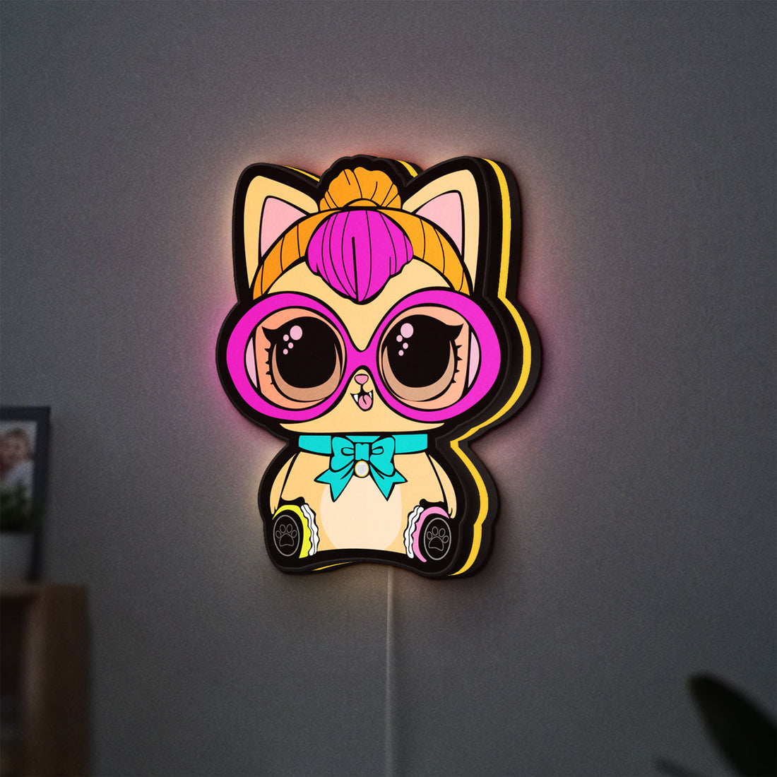L.O.L Surprise Cat LED lightbox hanging on a wall with yellow glow