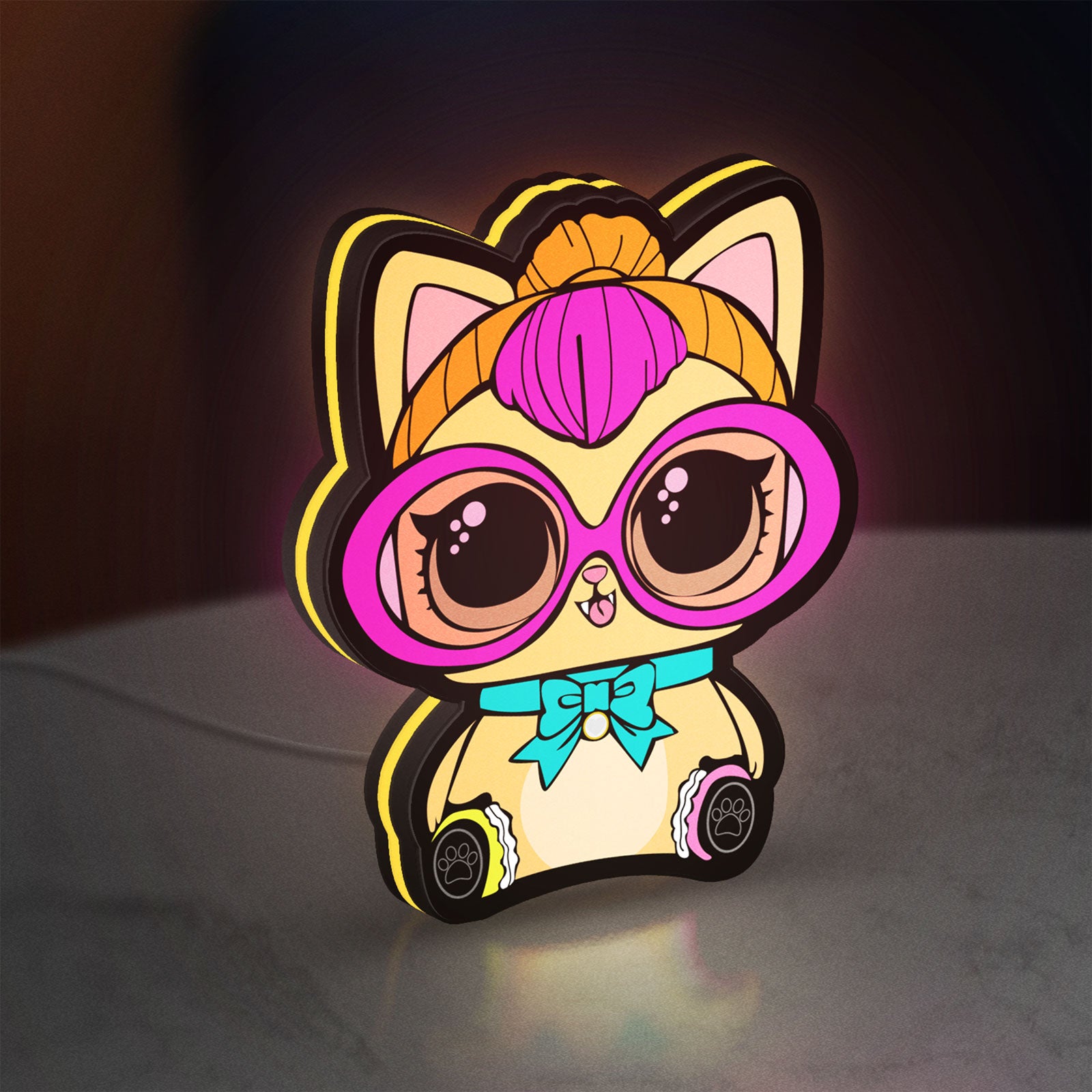 L.O.L Surprise Cat LED lightbox standing on a desk from an angled side view with yellow glow