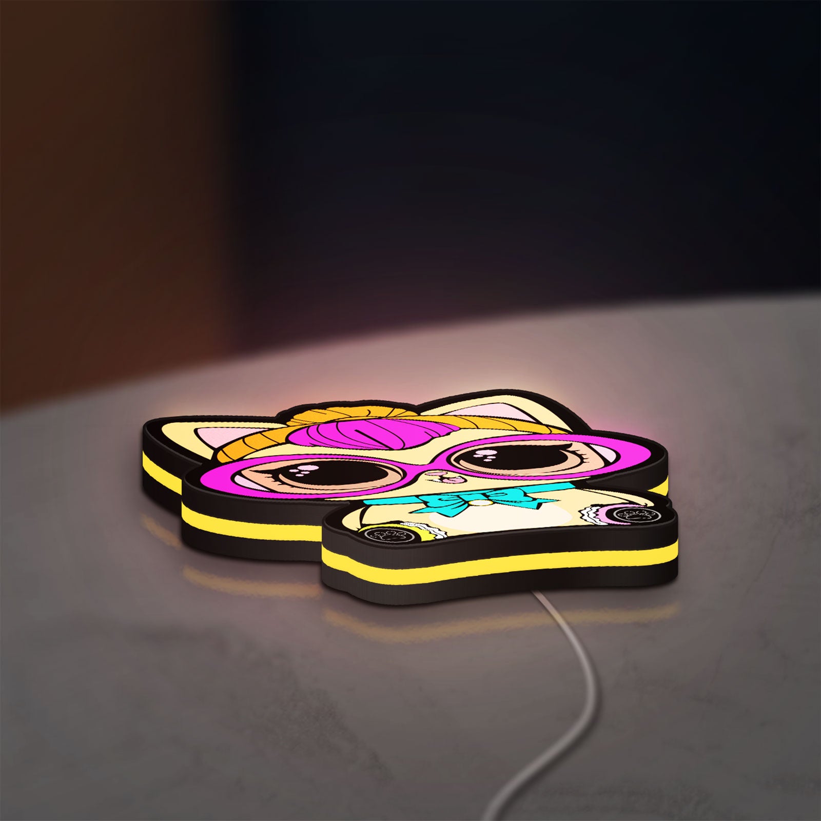 L.O.L Surprise Cat LED lightbox lying flat on a desk with yellow glow