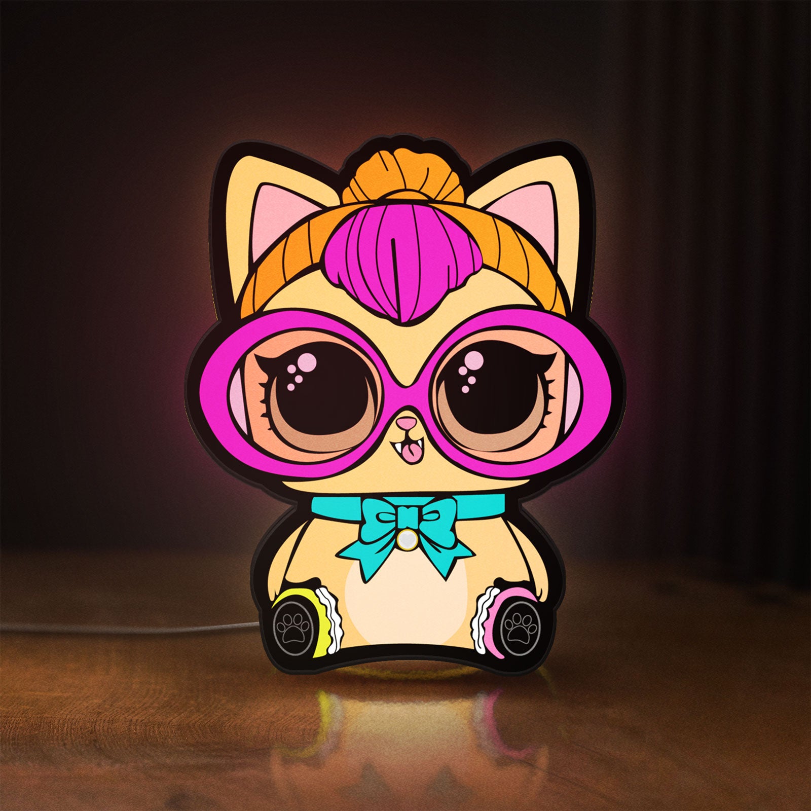 Front view of L.O.L Surprise Cat LED lightbox sign glowing on a wooden desk