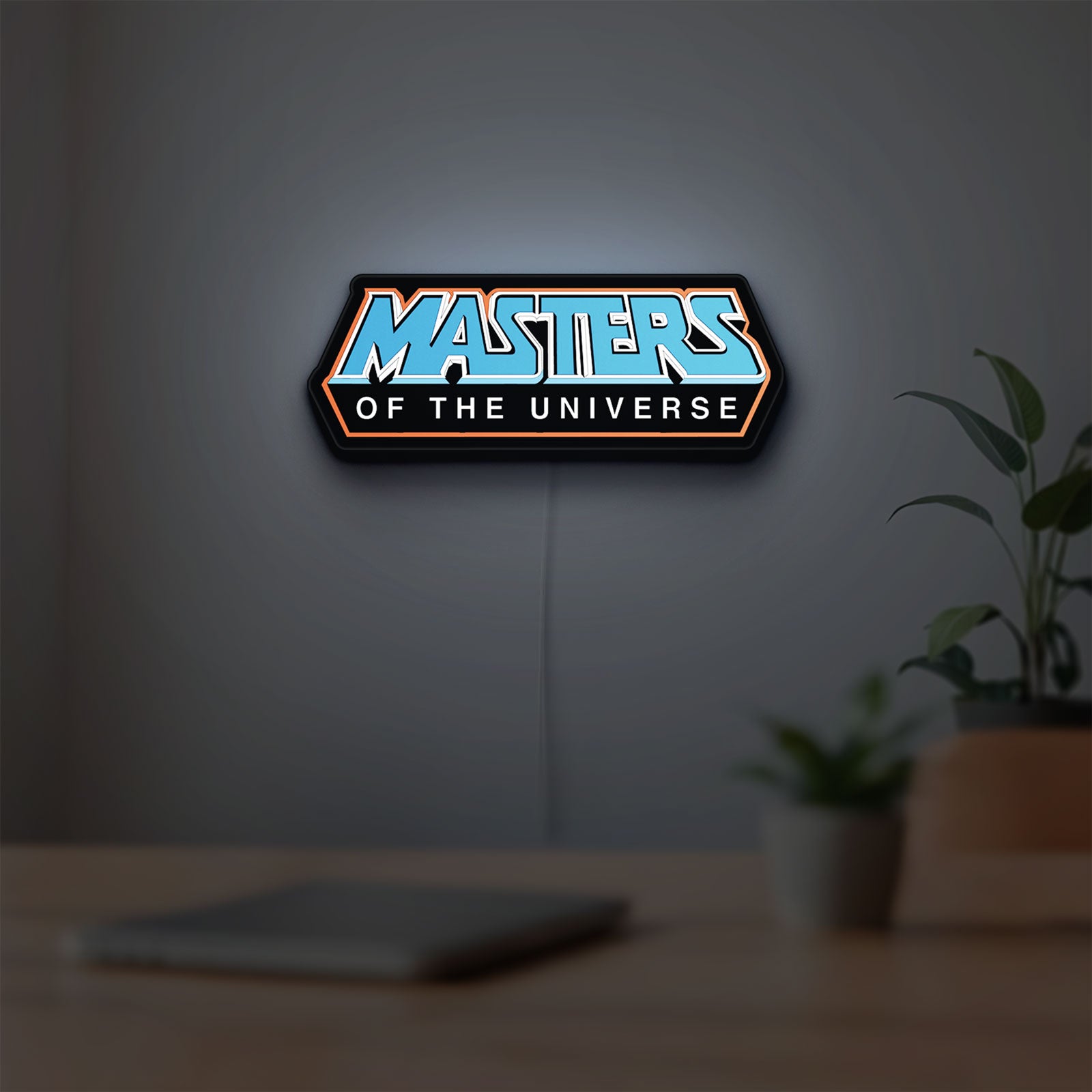 Masters of the Universe LED lightbox hanging on a room wall with soft blue light
