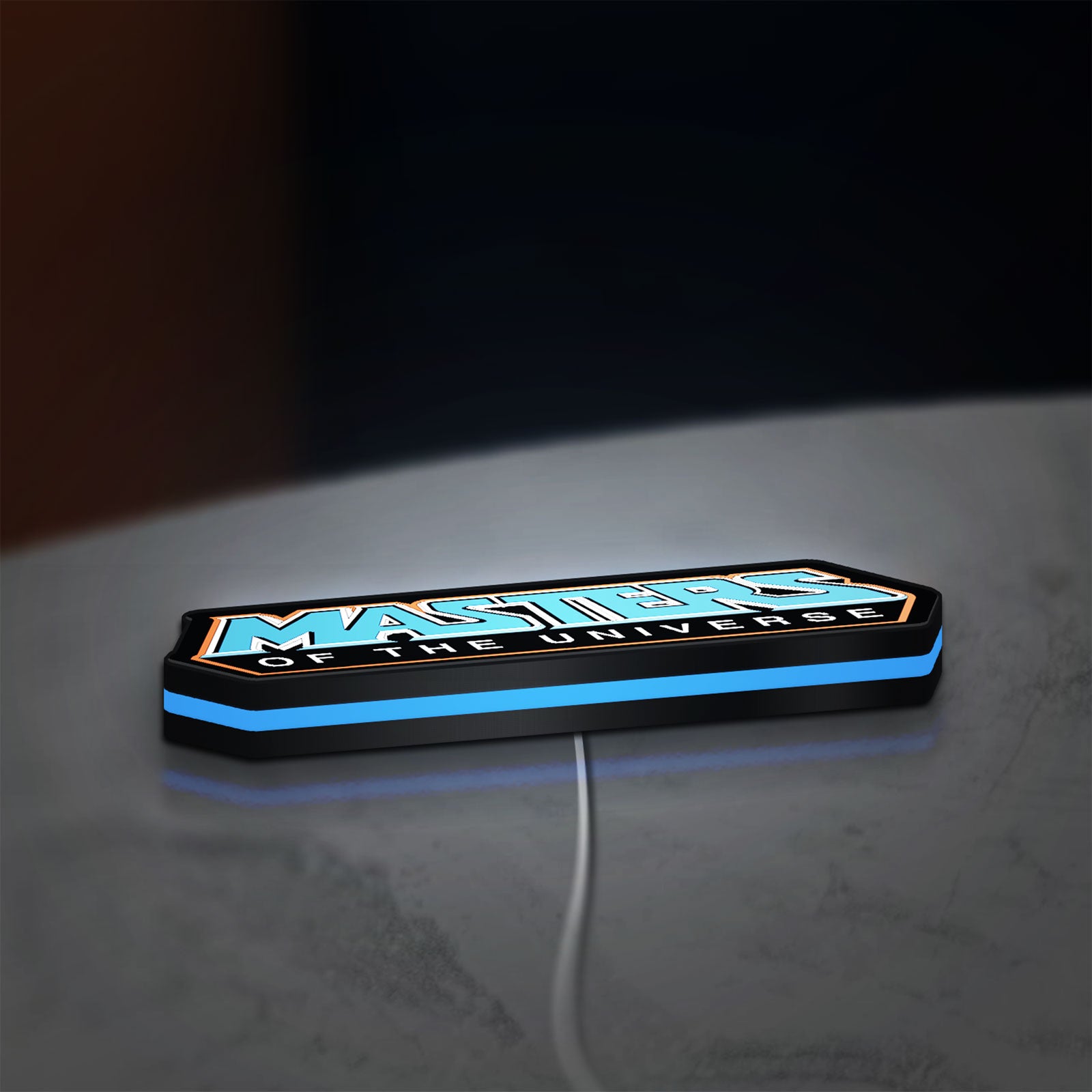 Masters of the Universe LED lightbox lying flat on a desk with blue glow