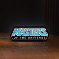 Front view of Masters of the Universe LED lightbox sign glowing on a wooden desk