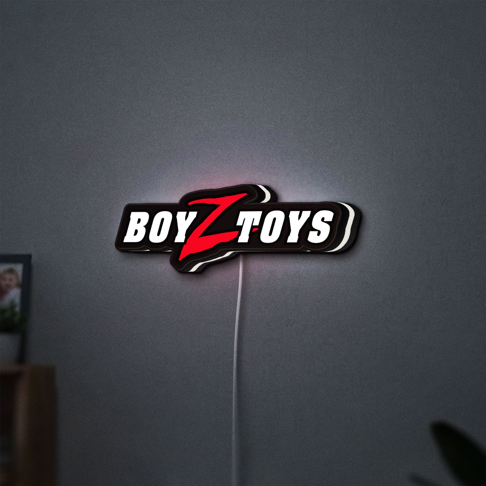 Boyztoys Racing LED lightbox hanging on a wall with white glow