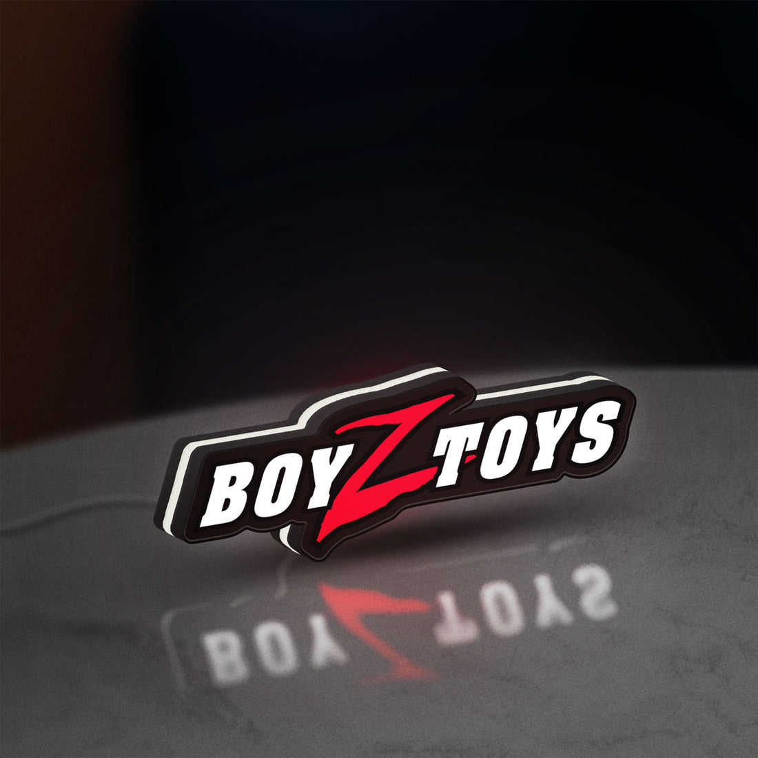 Boyztoys Racing LED lightbox hanging on a wall with white glow