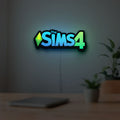 The Sims 4 Plumbob LED lightbox hanging on a room wall with soft green light