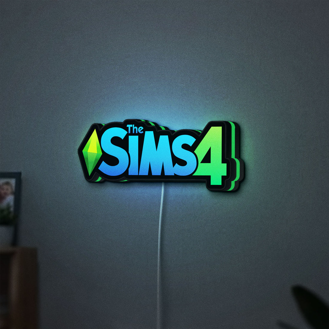 The Sims 4 Plumbob LED lightbox hanging on a wall with green glow