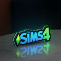 The Sims 4 Plumbob LED lightbox standing on a desk from an angled side view with green glow