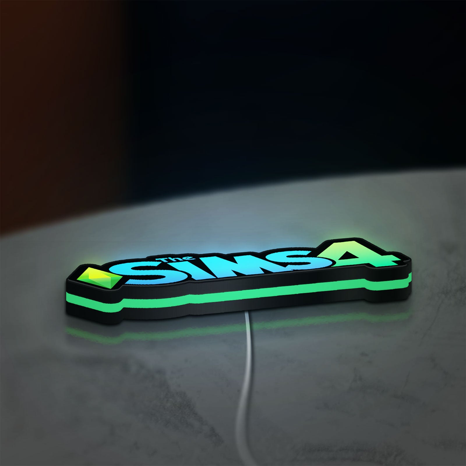 The Sims 4 Plumbob LED lightbox lying flat on a desk with green glow