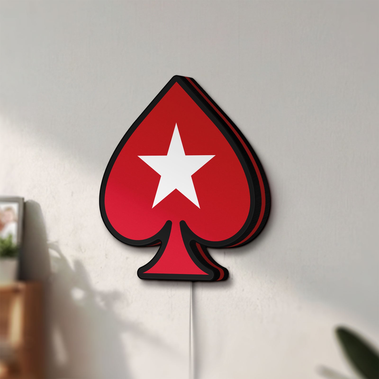 Unlit PokerStars Ace LED lightbox mounted on a wall in daylight