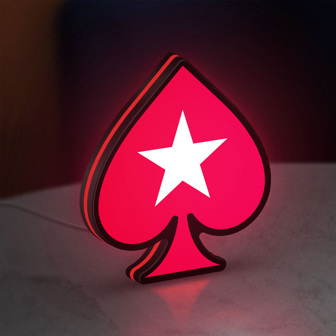 PokerStars Ace LED lightbox hanging on a wall with red glow