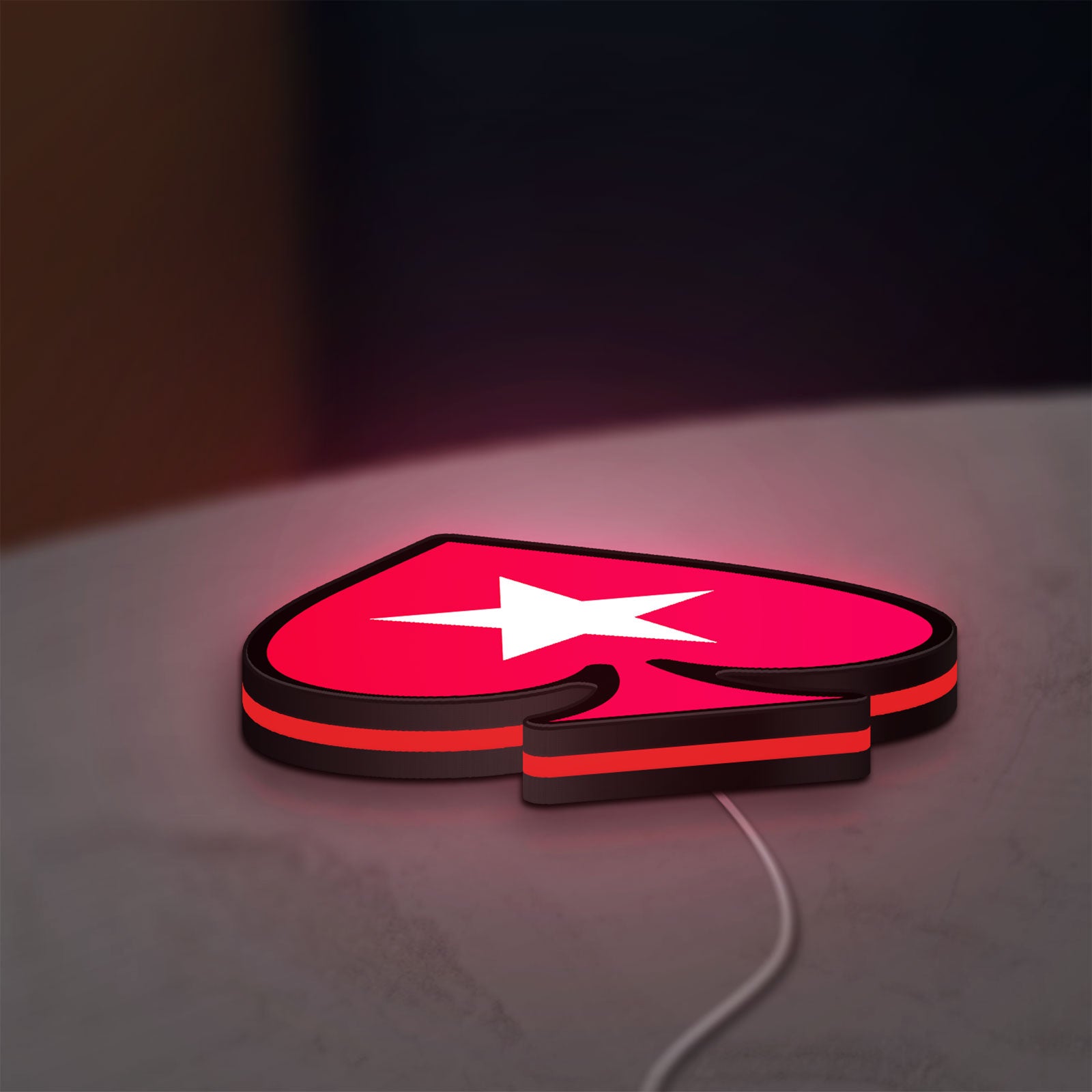 PokerStars Ace LED lightbox lying flat on a desk with red glow