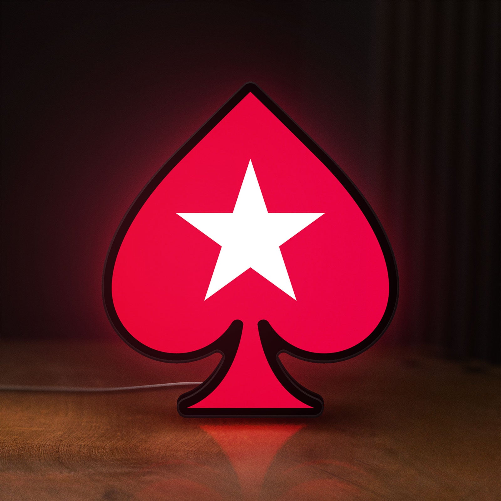Front view of PokerStars Ace LED lightbox sign glowing on a wooden desk