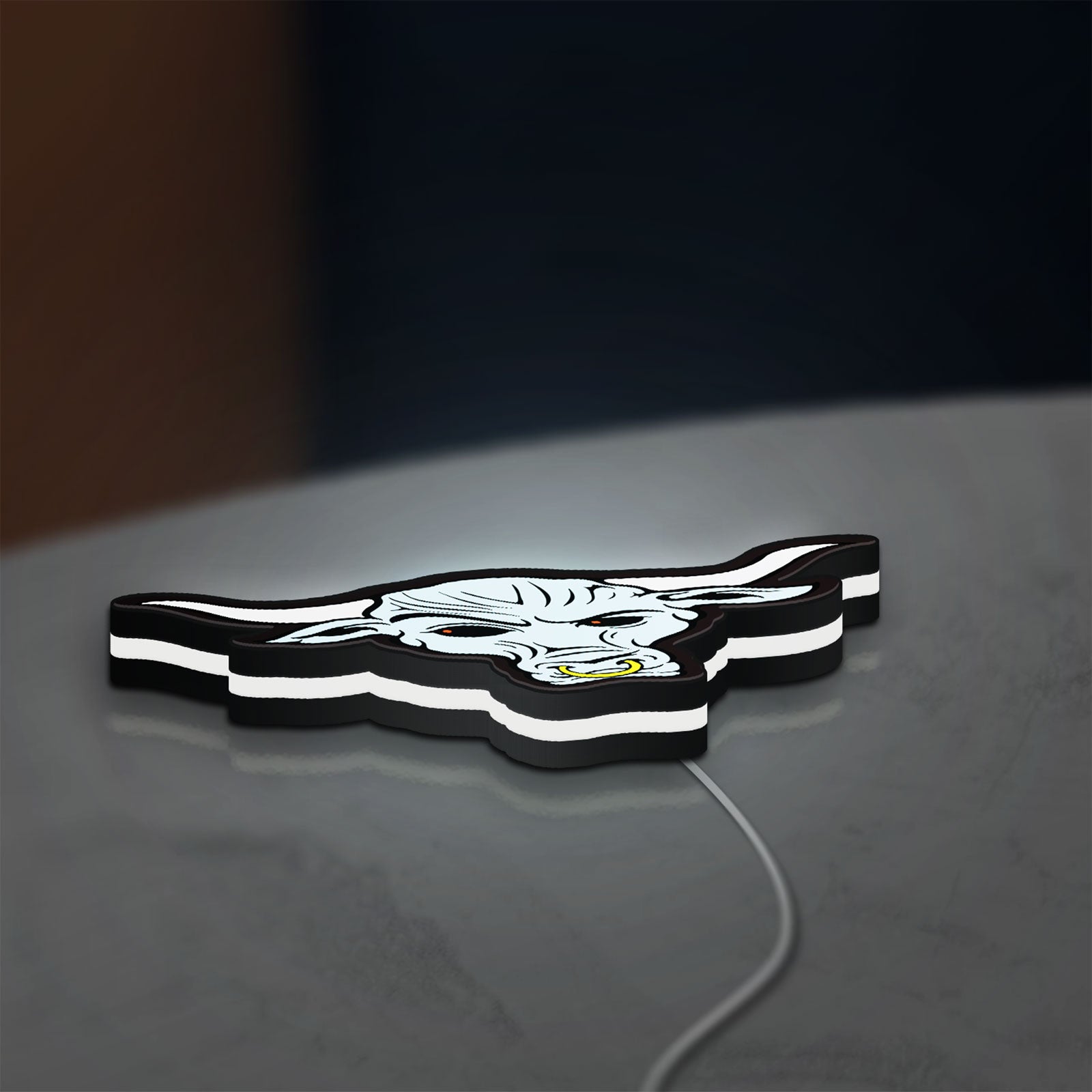 WWE Brahma Bull LED lightbox lying flat on a desk with white glow