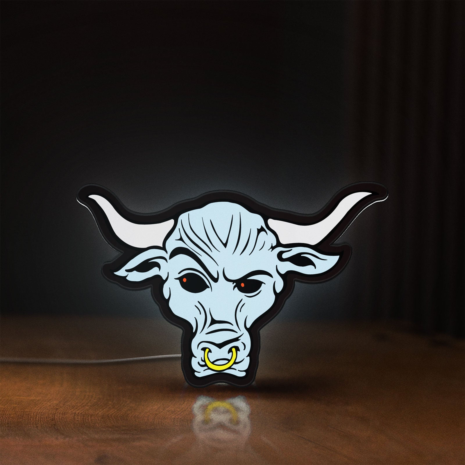 Front view of WWE Brahma Bull LED lightbox sign glowing on a wooden desk