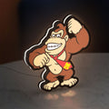 Donkey Kong LED lightbox standing on a desk from an angled side view with white glow