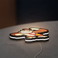 Donkey Kong LED lightbox lying flat on a desk with white glow