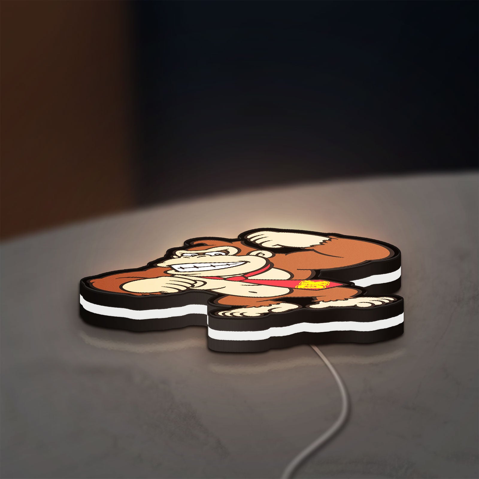 Donkey Kong LED lightbox lying flat on a desk with white glow