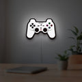 Sony PlayStation Pad LED lightbox hanging on a room wall with soft white light