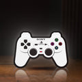 Front view of Sony PlayStation Pad LED lightbox sign glowing on a wooden desk