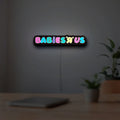 Babies R Us LED lightbox hanging on a room wall with soft white light