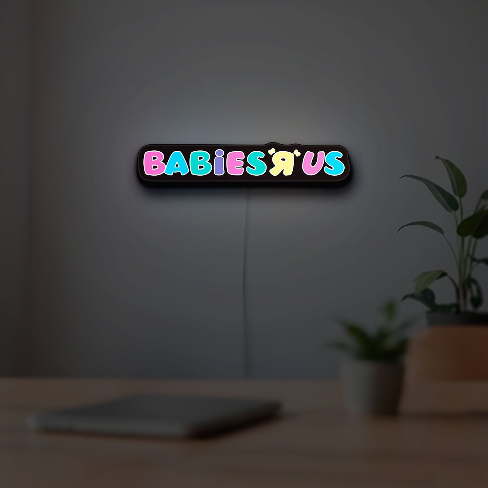 Babies R Us LED lightbox hanging on a room wall with soft white light