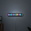Babies R Us LED lightbox hanging on a wall with white glow