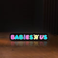 Front view of Babies R Us LED lightbox sign glowing on a wooden desk