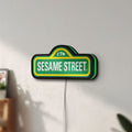 Unlit Sesame Street LED lightbox mounted on a wall in daylight