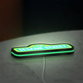 Sesame Street LED lightbox lying flat on a desk with green glow