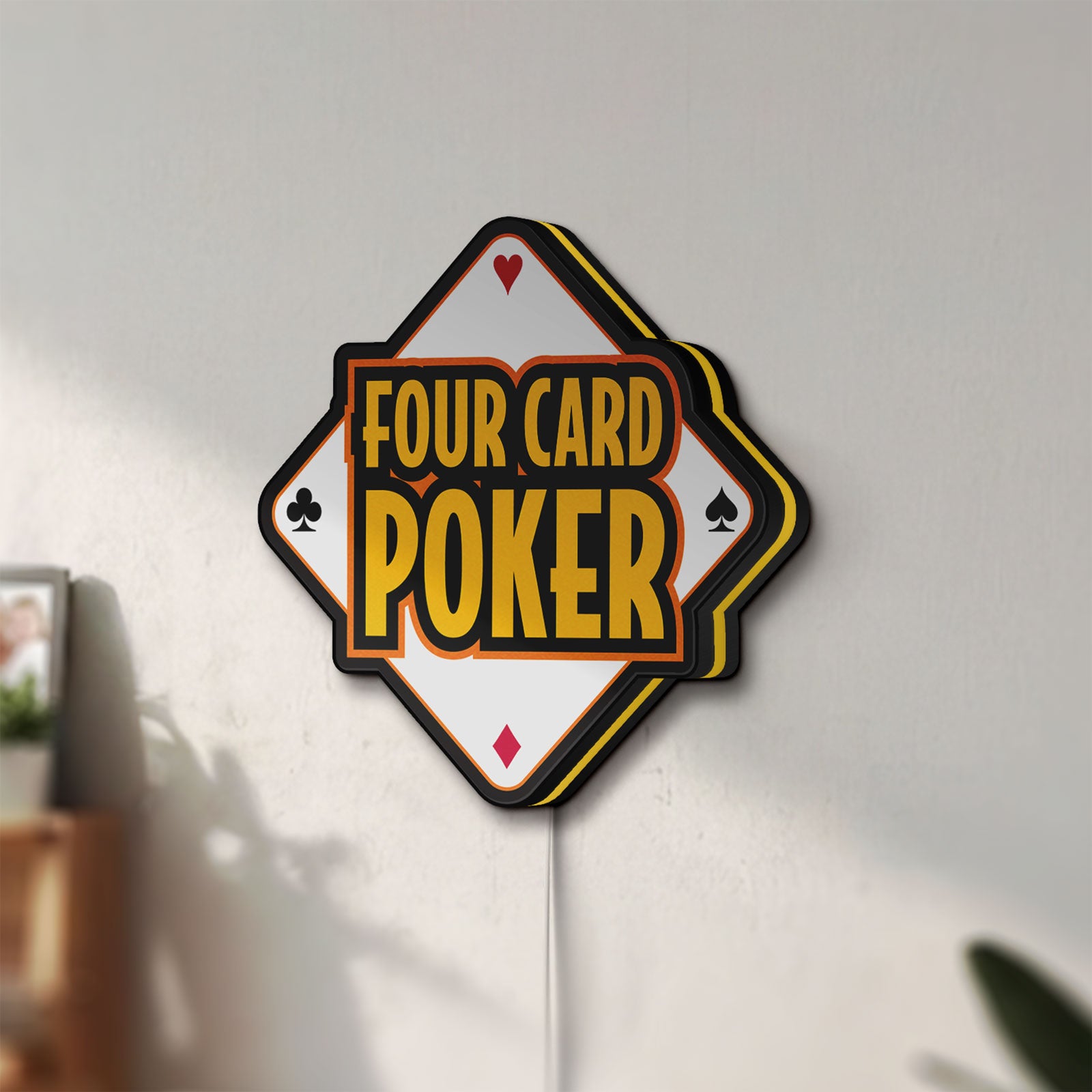 Unlit Four Card Poker LED lightbox mounted on a wall in daylight
