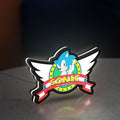 Sonic the Hedgehog LED lightbox standing on a desk from an angled side view with white glow