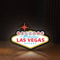 Front view of Las Vegas Nevada LED lightbox sign glowing on a wooden desk