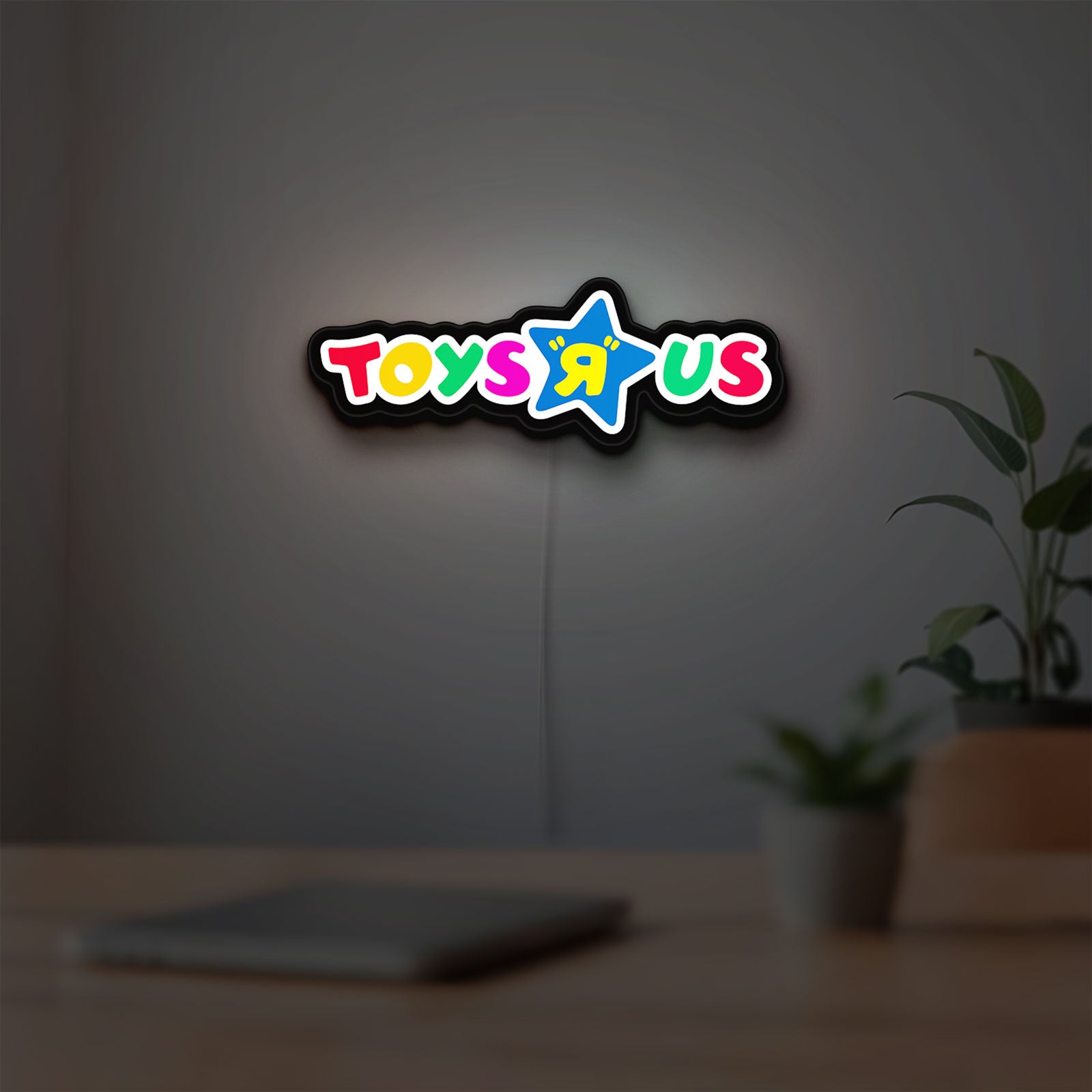 Toys R Us LED lightbox hanging on a room wall with soft white light